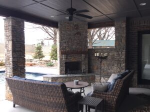 outdoor fireplace with sofa set and coffee table