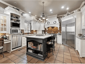 A large kitchen with white cabinets and a center island.