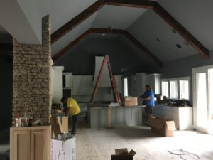 A kitchen is being remodeled with wood beams.