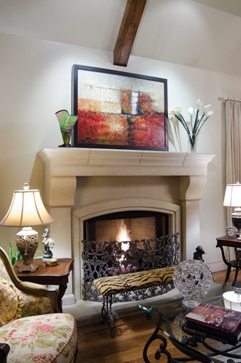 A living room with a fireplace and chairs.