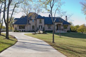 A driveway leading to a large house.