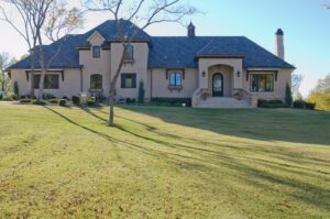 A home with a large lawn and trees.