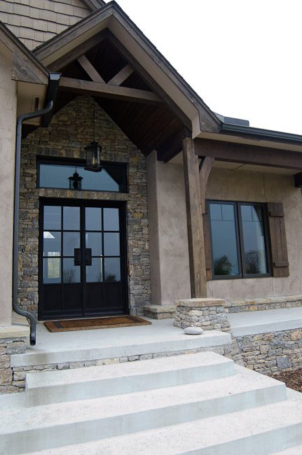 A house with steps leading to the front door.