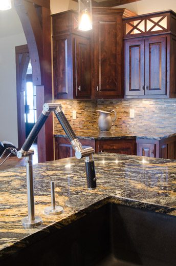 A kitchen with granite counter tops and wooden cabinets.