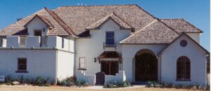 A white house with a brown roof.