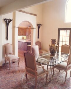 A dining room with a table and chairs.