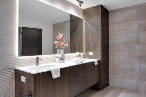 A modern bathroom with two sinks and a mirror.