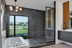 A modern bathroom with a glass shower stall.