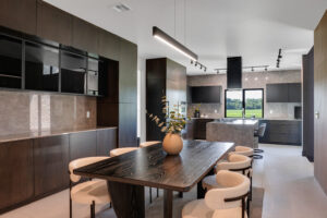 A modern kitchen with a dining table and chairs.