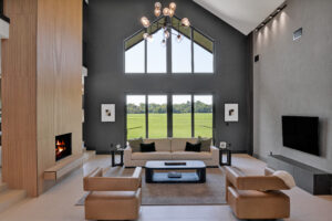 A living room with a fireplace and large windows.