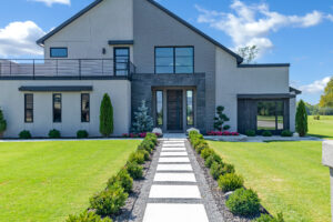 A modern home with a pathway leading to the front door.