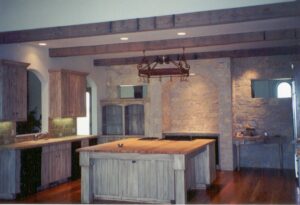 A kitchen with wood floors and a wooden island.