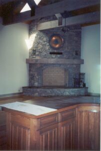 A stone fireplace in the middle of a room.