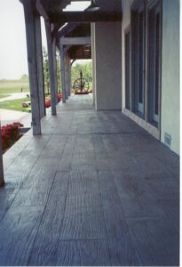 A concrete walkway in front of a house.